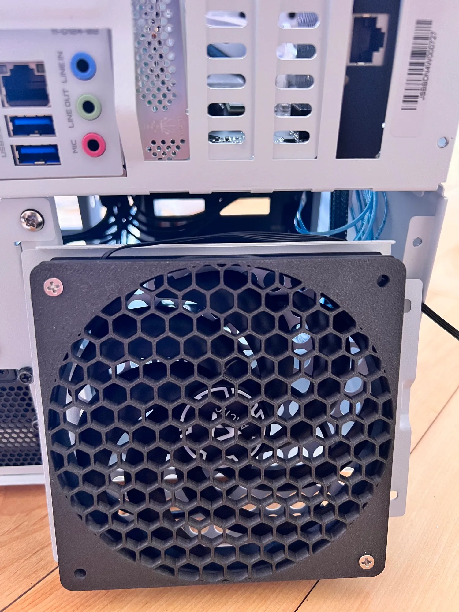 The rear fan behind its printed honeycomb grille